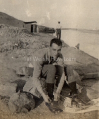 953, Williams putting boots on in front of Suez Canal